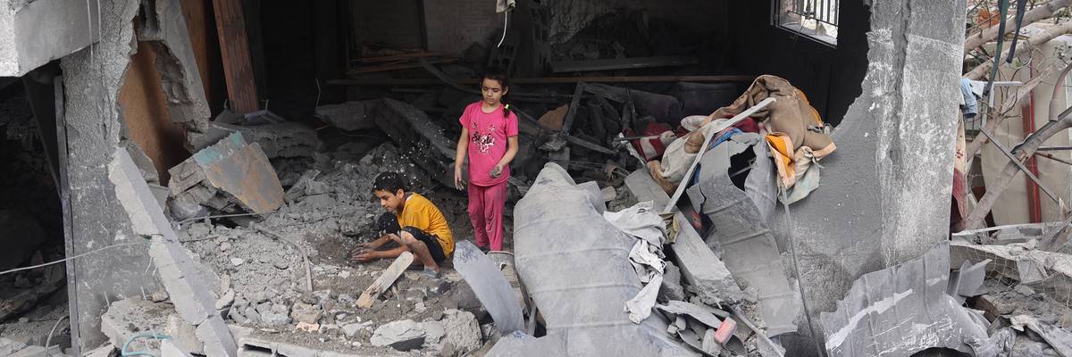 Palestinian children search rubble in Gaza.