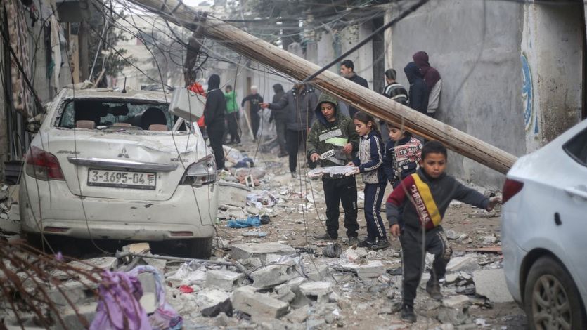 Palestinian children search rubble in Rafah