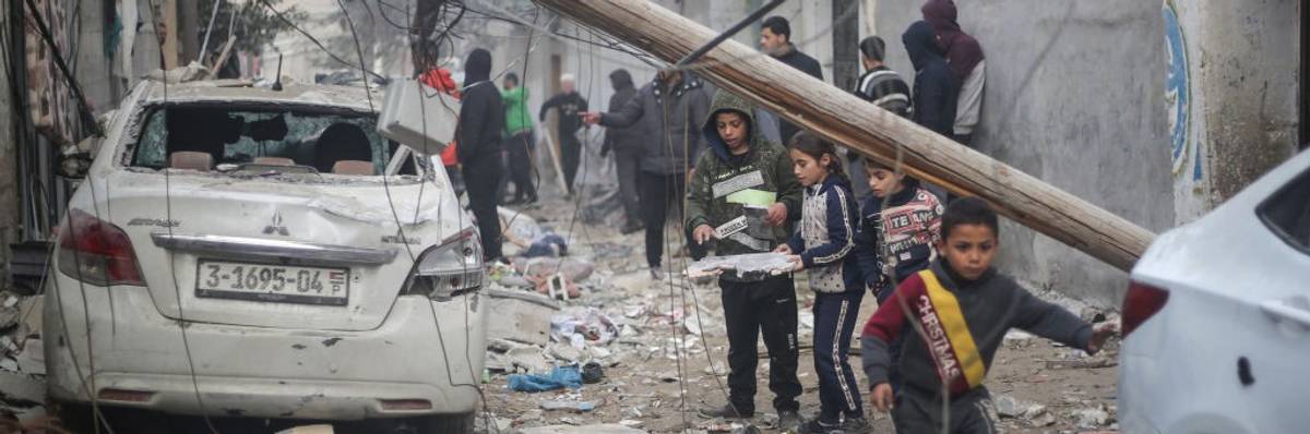 Palestinian children search rubble in Rafah