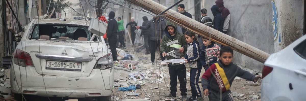 Palestinian children search rubble in Rafah