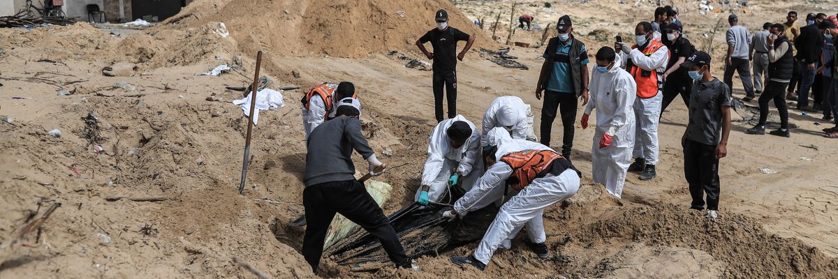 Palestinian civil defense workers remove bodies from rubble in Khan Younis.