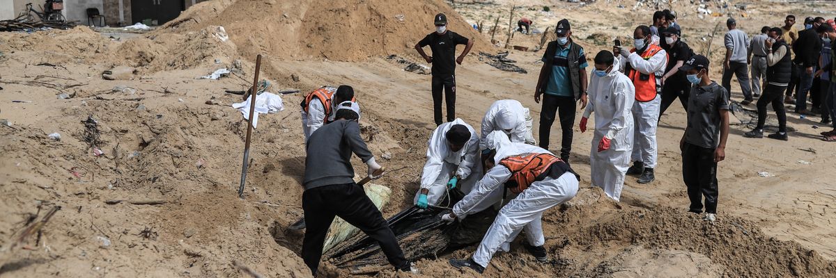Palestinian civil defense workers remove bodies from rubble in Khan Younis.