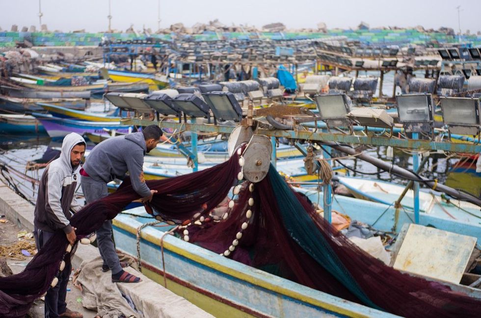 Palestinian fishermen prepare their nets in Gaza's port before going out to sea. Photo by Kaamil Ahmed/Mongabay.