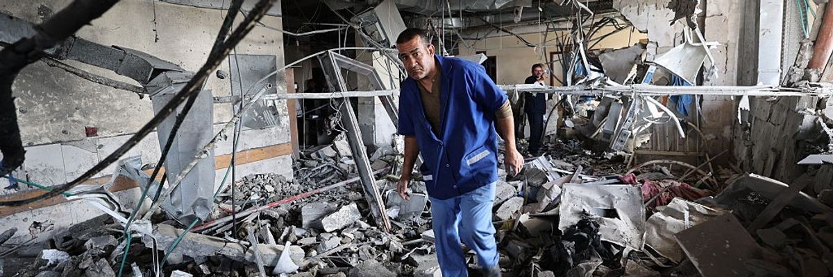Palestinian hospital staff inspect the destruction inside Nasser Hospital