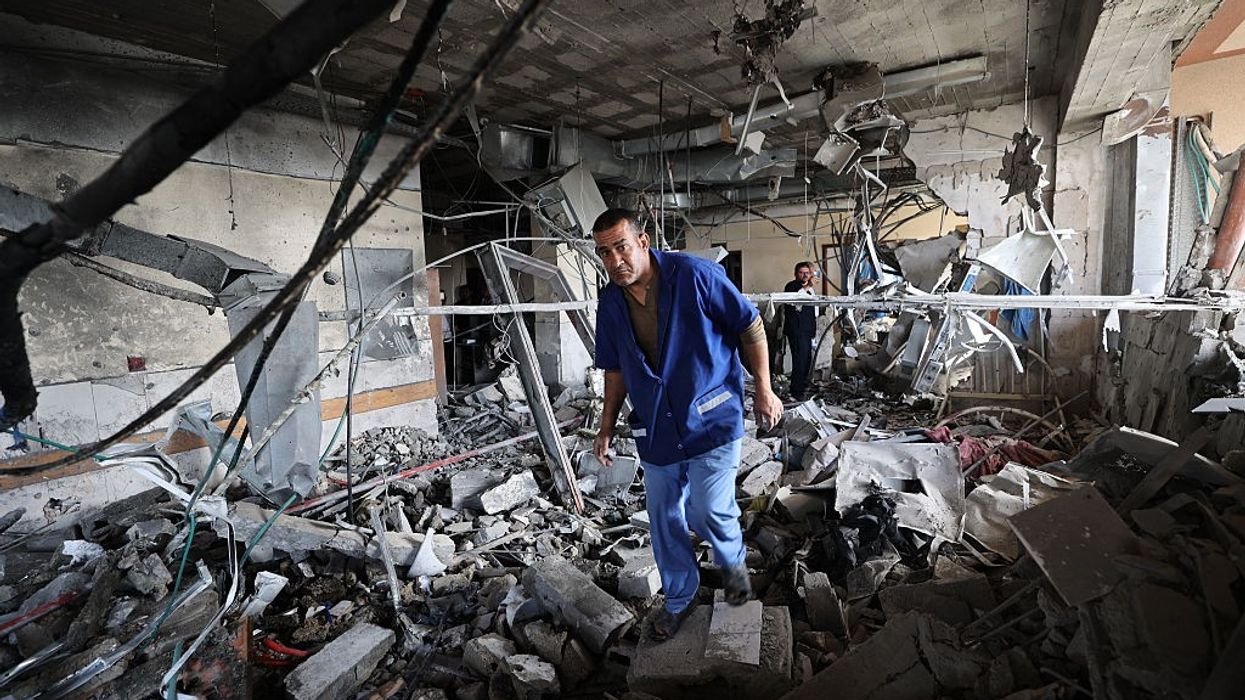 Palestinian hospital staff inspect the destruction inside Nasser Hospital