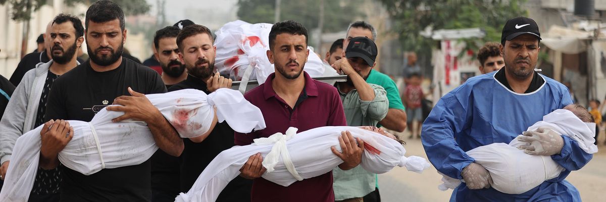 Palestinian men carry civilians—including children wrapped in white cloths—killed by Israeli attacks on Gaza.