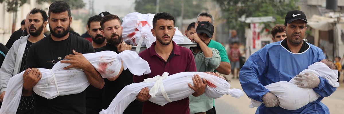 Palestinian men carry civilians—including children wrapped in white cloths—killed by Israeli attacks on Gaza.