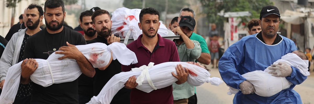 Palestinian men carry civilians—including children wrapped in white cloths—killed by Israeli attacks on Gaza.