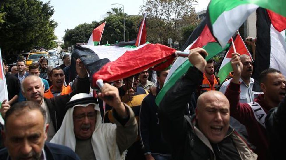 Palestinian men march on March 31, 2018 in the Israeli occupied West Bank city of Nablus in a symbolic funeral in solidarity with those who were killed a day earlier in the Gaza Strip during clashes with Israeli forces on Land Day. (Photo: AFP)