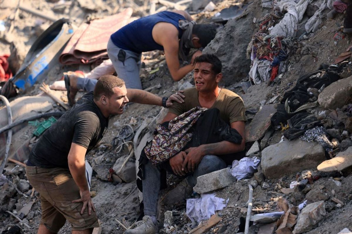 palestinian-men-mourn-on-a-pile-of-rubble-after-israeli-airstrike.jpg?id=50990637&width=1200&height=800&quality=90&coordinates=0%2C0%2C0%2C1