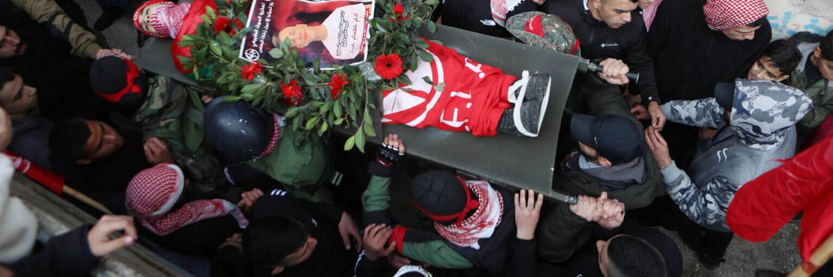 Palestinian mourners carry the body of 15-year-old Adam Ayyad during his funeral at Bethlehem’s Dheisheh refugee camp on January 3.