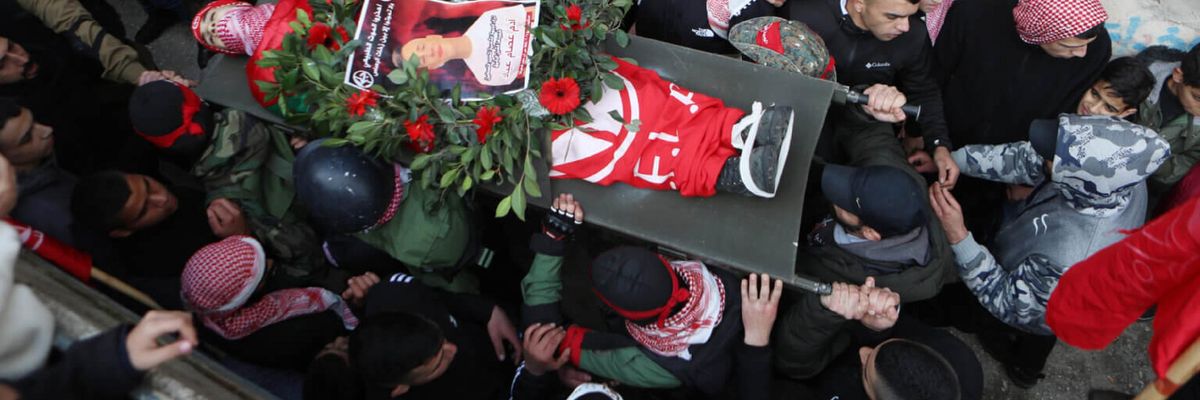 Palestinian mourners carry the body of 15-year-old Adam Ayyad during his funeral at Bethlehem’s Dheisheh refugee camp  on January 3. 