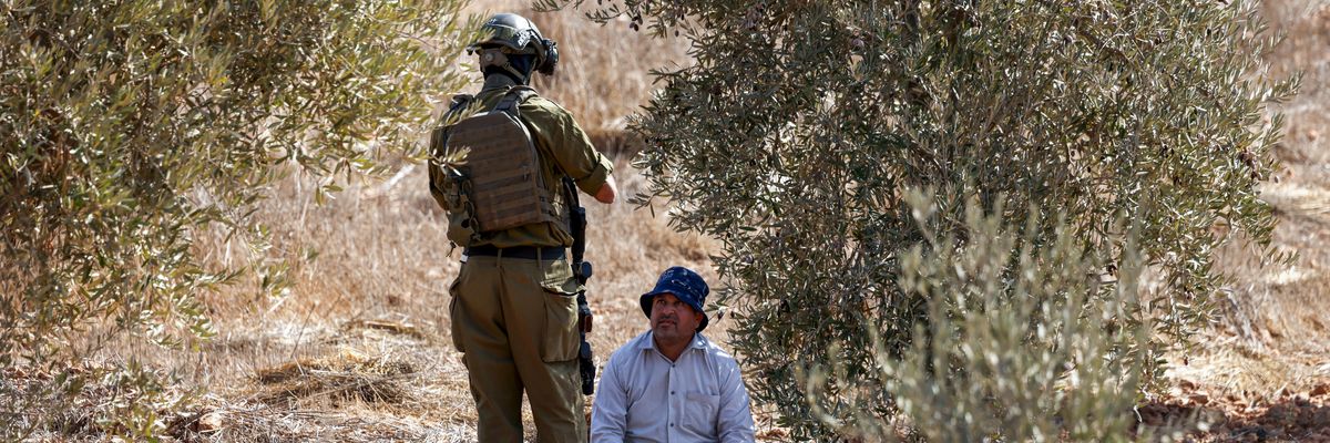 Palestinian olive farmer and Israeli soldier
