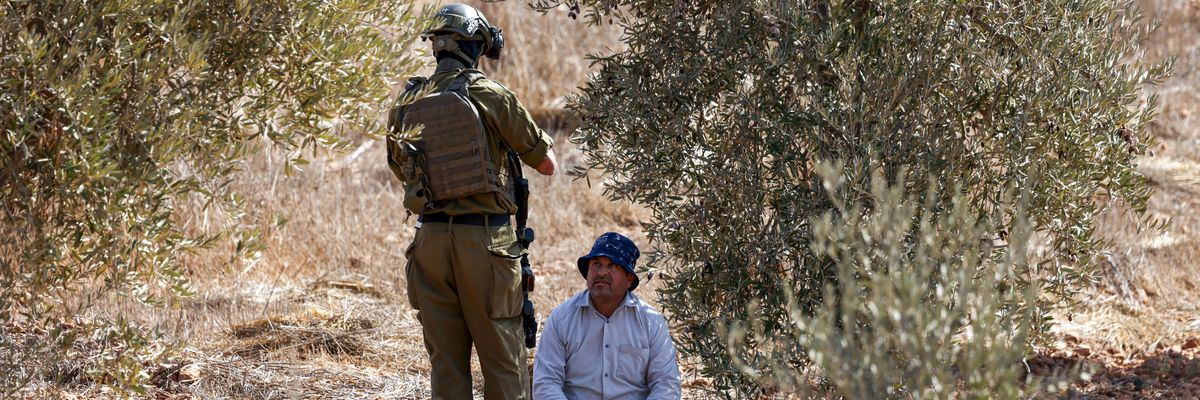 Palestinian olive farmer and Israeli soldier