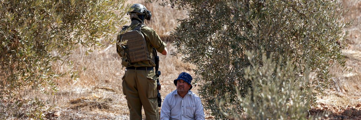 Palestinian olive farmer and Israeli soldier