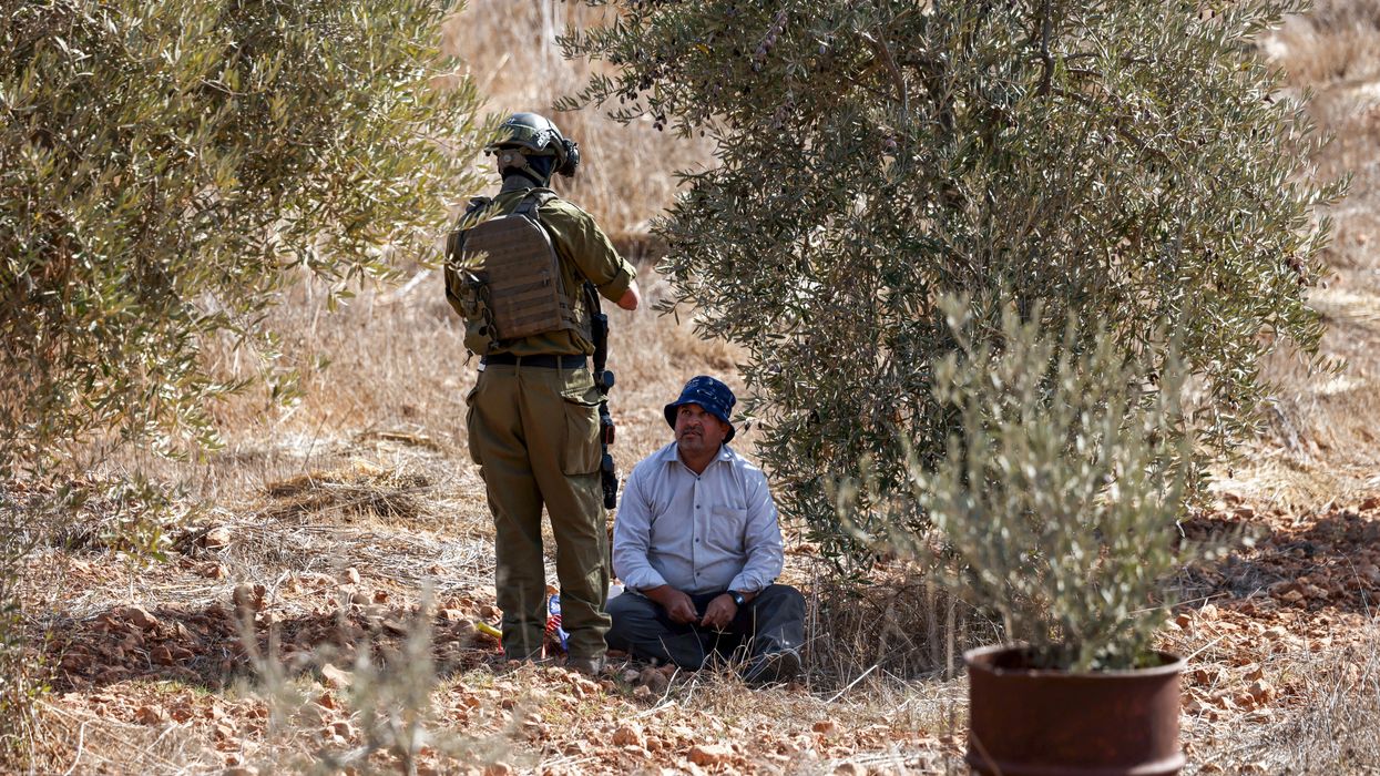 Palestinian olive farmer and Israeli soldier