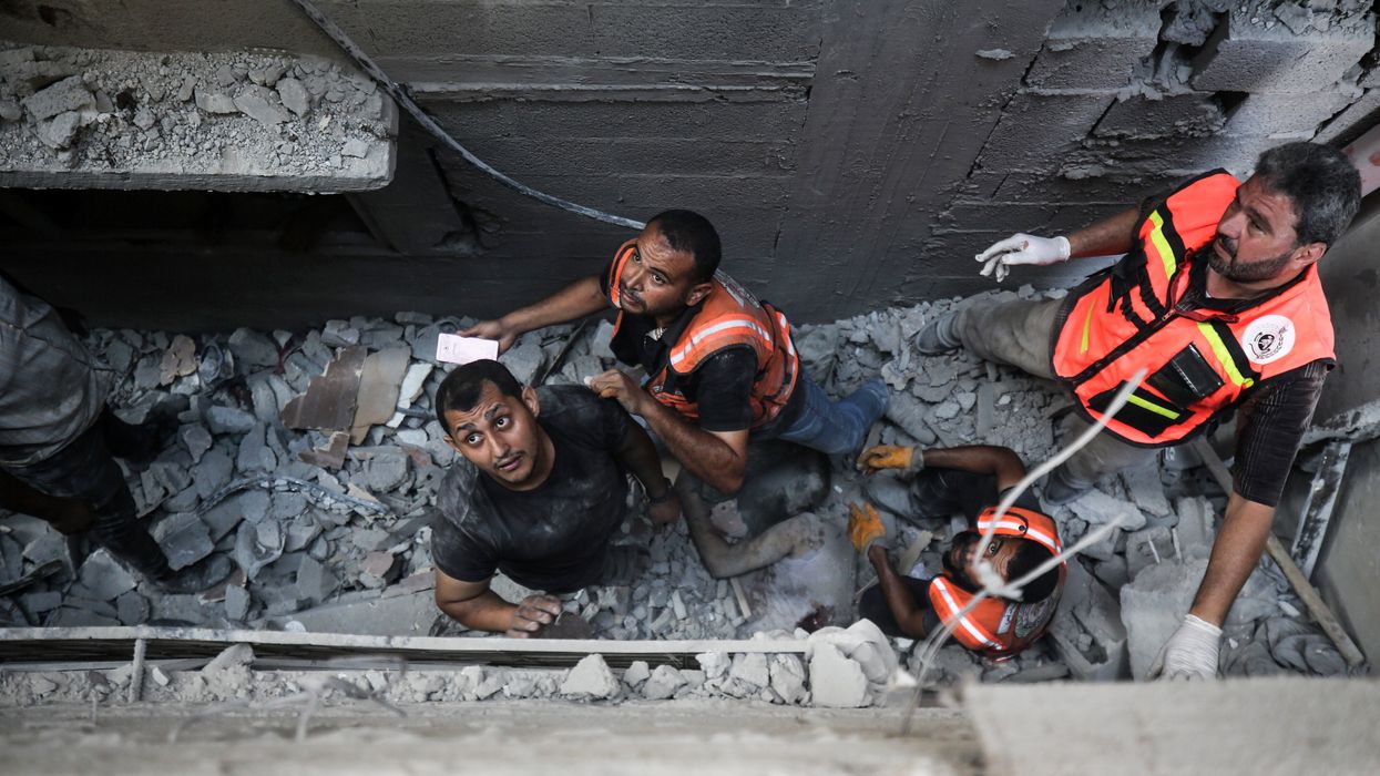 Palestinian rescue workers search rubble