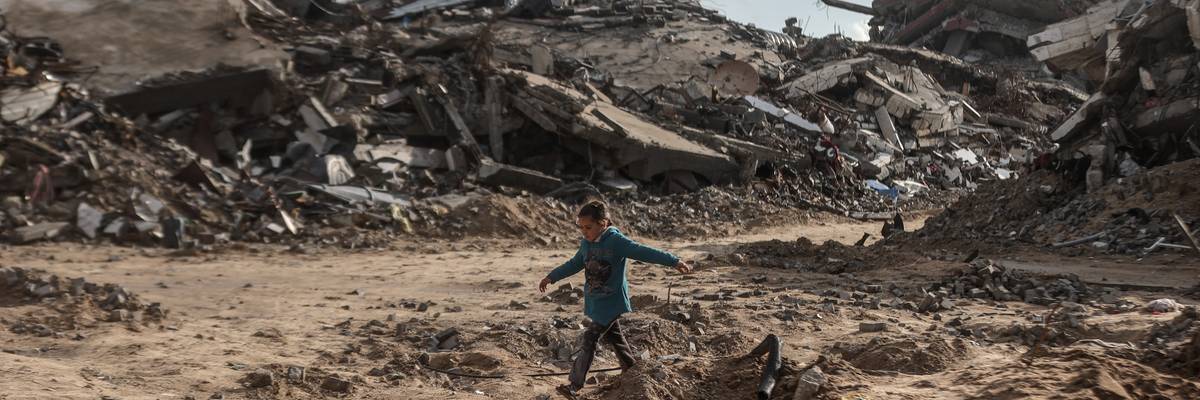 Palestinian walks through rubble in Gaza.