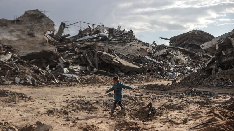 Palestinian walks through rubble in Gaza.