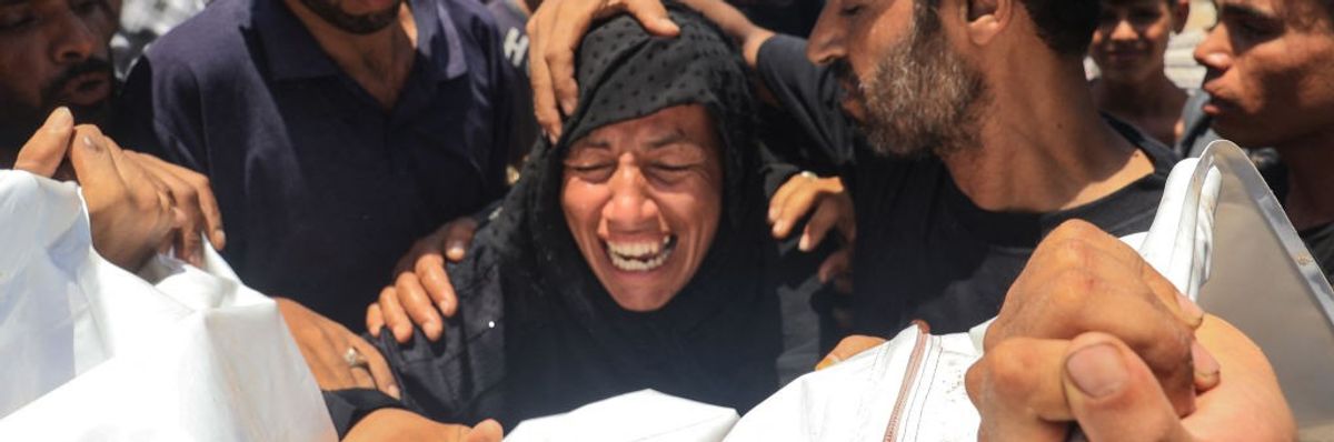 Palestinian woman cries over dead body of family member