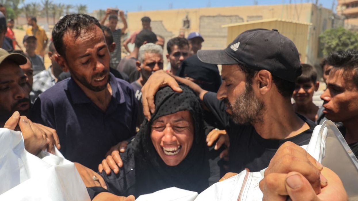 Palestinian woman cries over dead body of family member