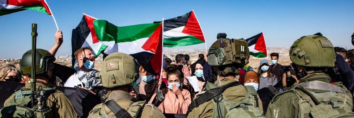 Palestinians, accompanied by Israeli and international activists, demonstrate on 8 January, 2021 in Hebron