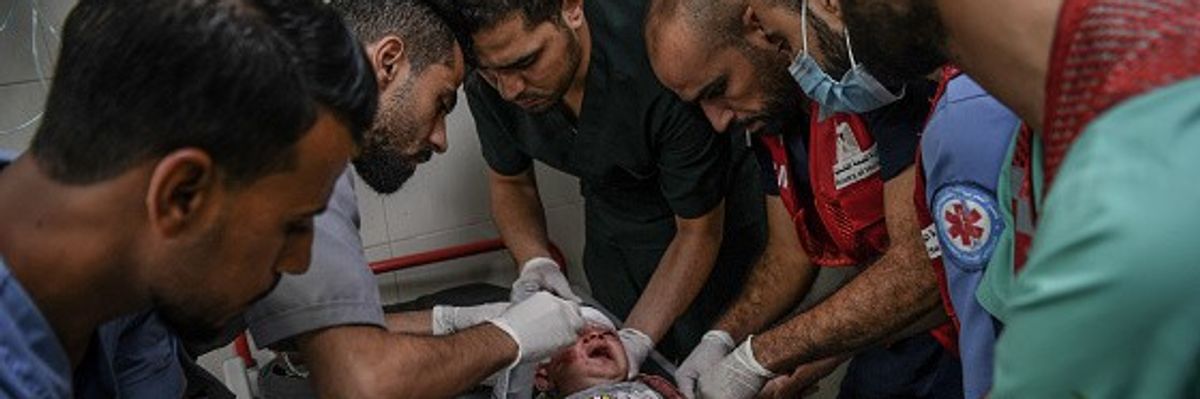 Palestinians attend injured baby in Al-Nasir Hospital in Khan Yunis, Gaza
