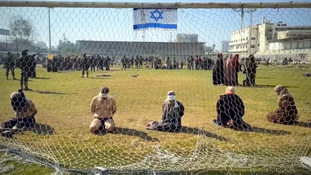 Palestinians blindolded and on their knees in Israeli captivity in Gaza's Yarmouk Stadium.