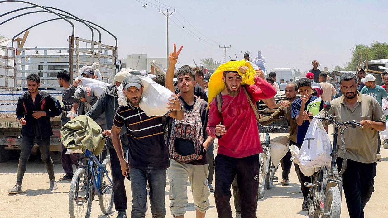 Palestinians carry aid