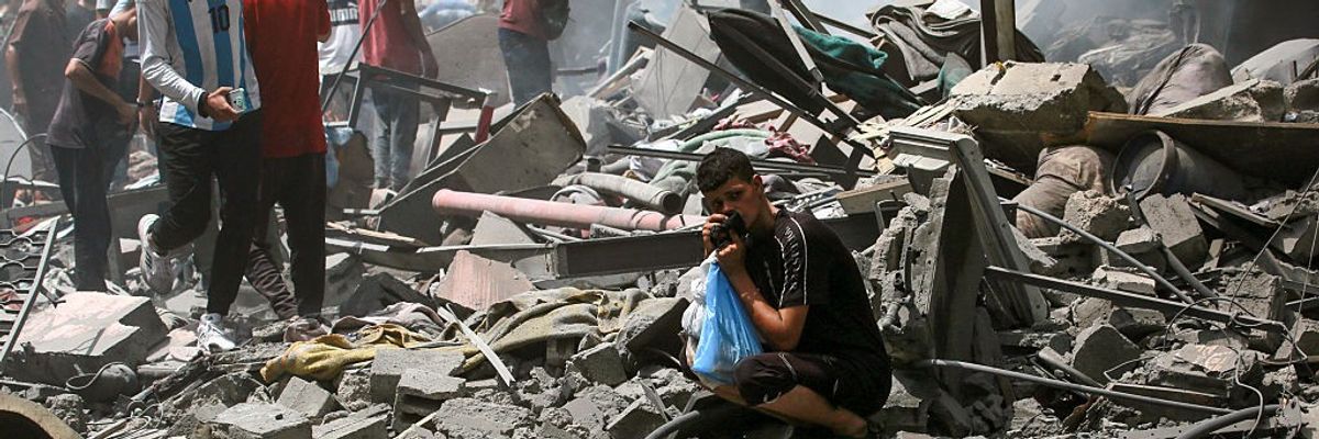 Palestinians check the devastation following an Israeli strike that hit Gaza City