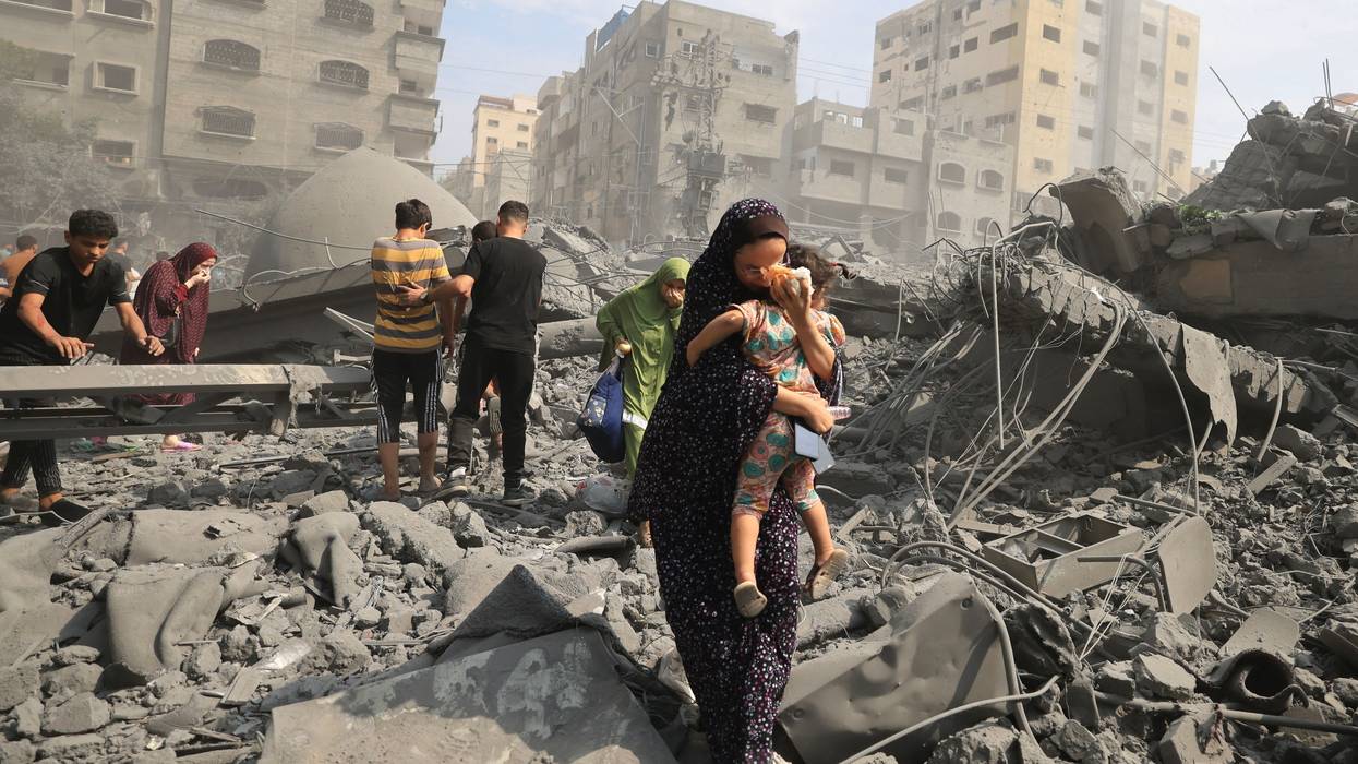 Palestinians evacuate following an Israeli airstrike on Gaza