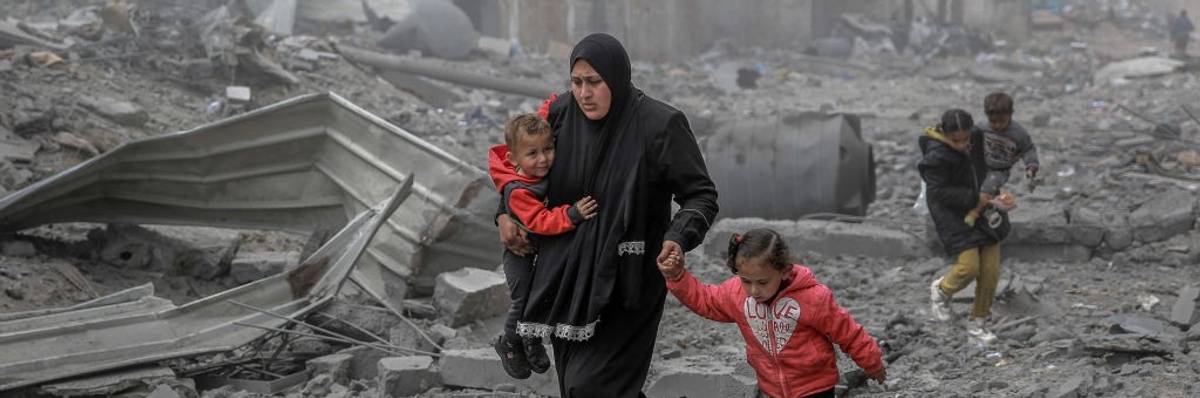 Palestinians flee after Israeli bombardment in central Gaza City on March 18, 2024.