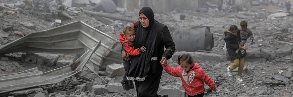 Palestinians flee after Israeli bombardment in central Gaza City on March 18, 2024.