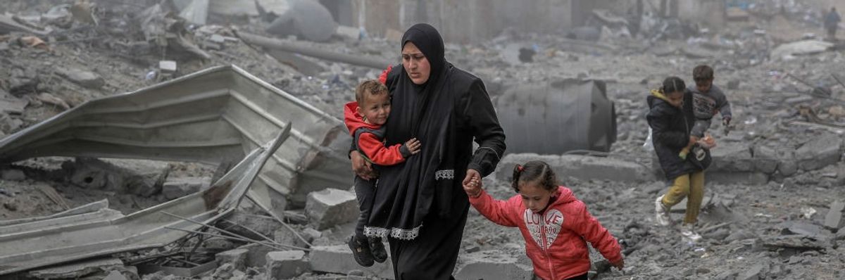 Palestinians flee after Israeli bombardment in central Gaza City on March 18, 2024.