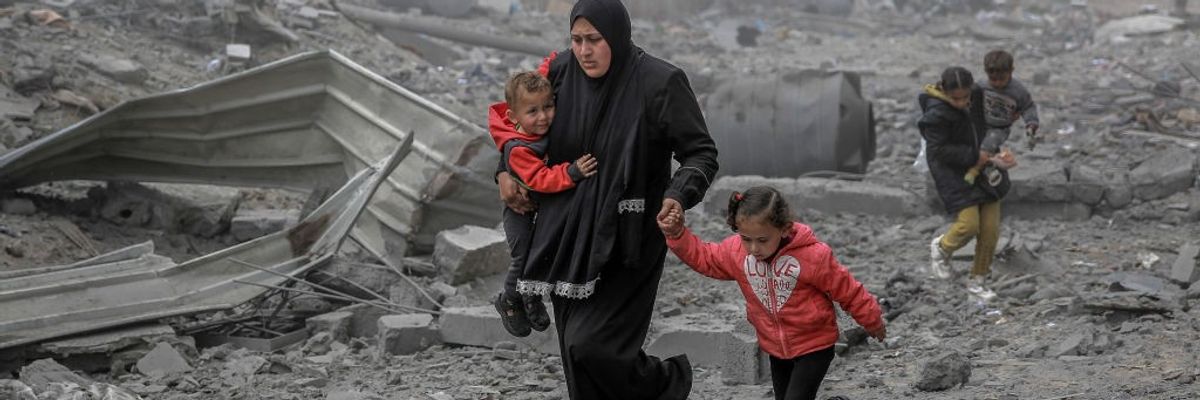 Palestinians flee after Israeli bombardment in central Gaza City on March 18, 2024.