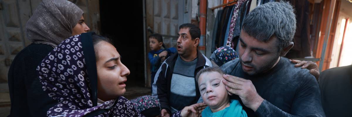 Palestinians flee with child in Rafah.