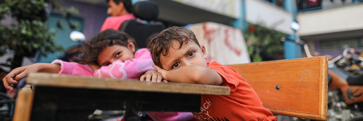 Palestinians fleeing Israeli attacks take shelter at a UNRWA school