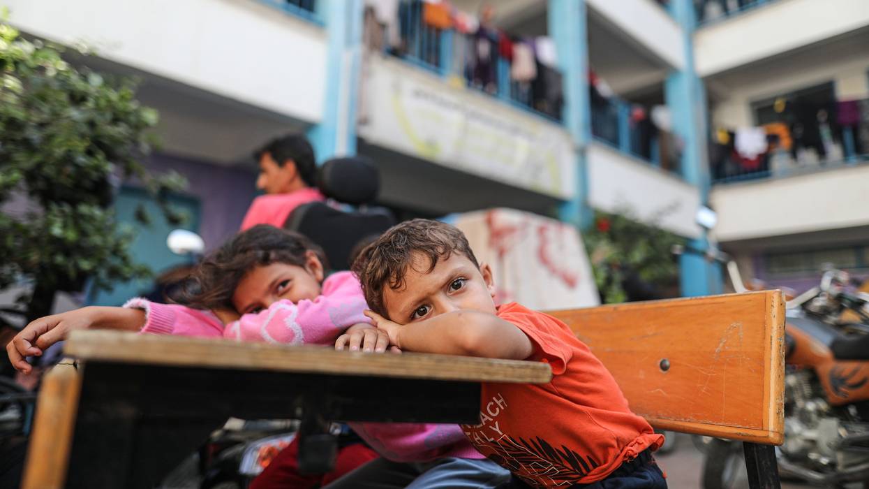 Palestinians fleeing Israeli attacks take shelter at a UNRWA school