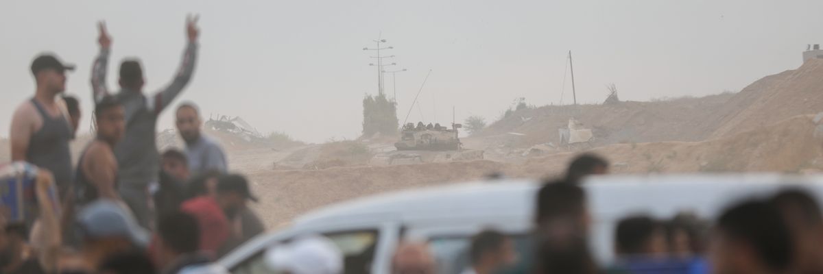 Palestinians go to an aid distribution point in the Netzarim Corridor