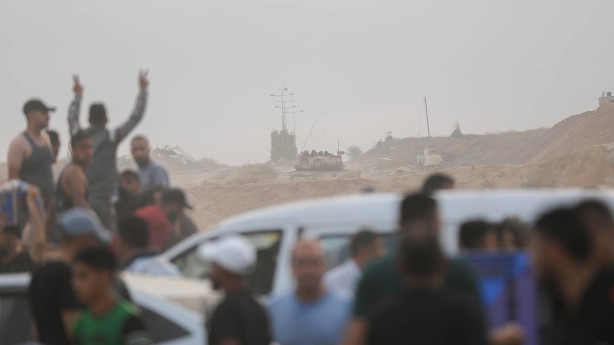 Palestinians go to an aid distribution point in the Netzarim Corridor