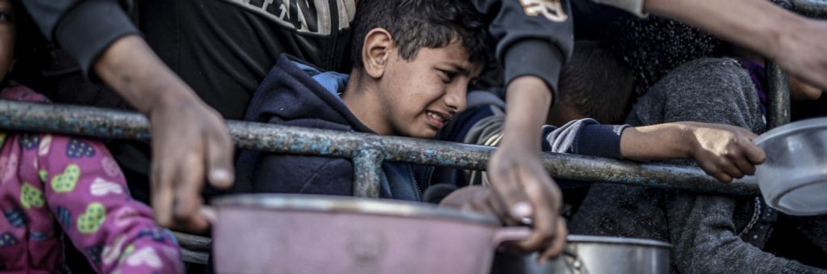 Palestinians in Rafah, Gaza, receive food