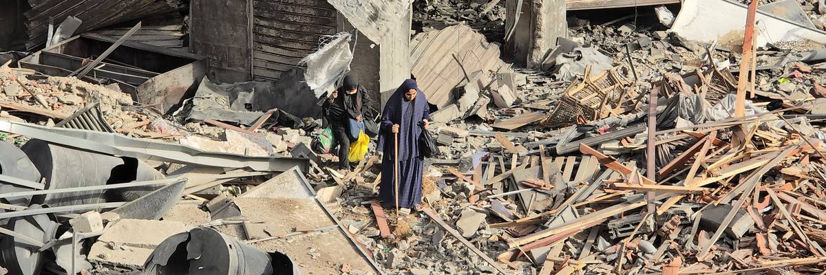 Palestinians in wreckage of Kamal Adwan hospital.