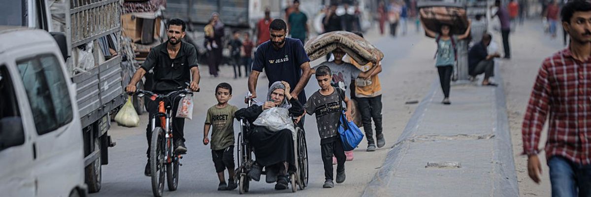 Palestinians including a woman in a wheelchair flee Zeitoun
