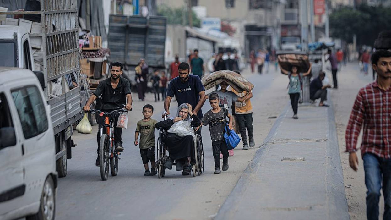 Palestinians including a woman in a wheelchair flee Zeitoun