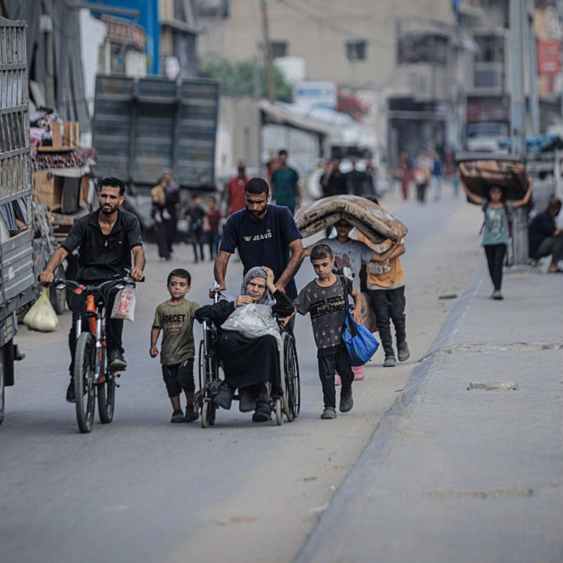 Palestinians, including children and a woman in a wheelchair, flee Gaza City