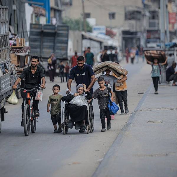 Palestinians, including children and a woman in a wheelchair, flee Gaza City