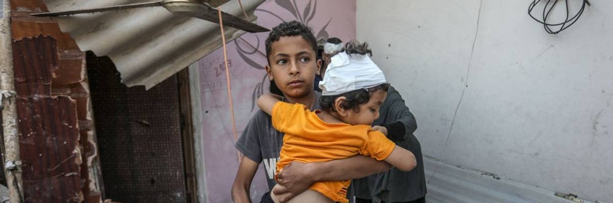 Palestinians, including children, collect remaining belongings