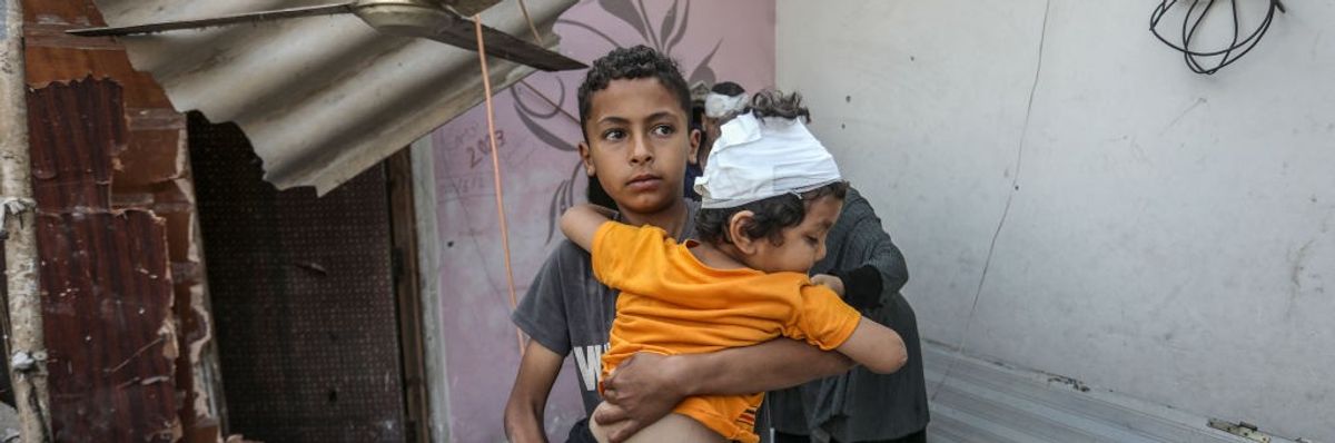 Palestinians, including children, collect remaining belongings