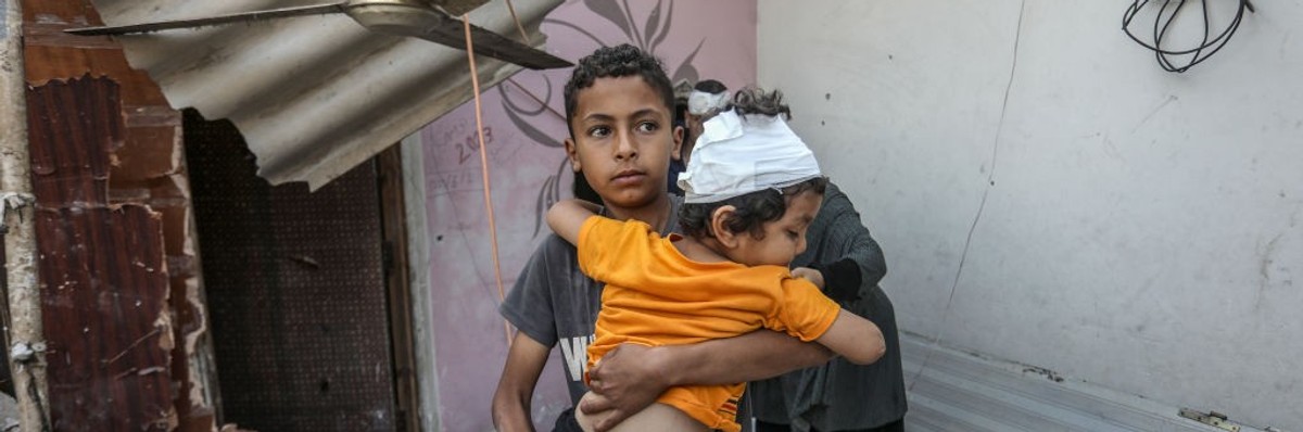 Palestinians, including children, collect remaining belongings