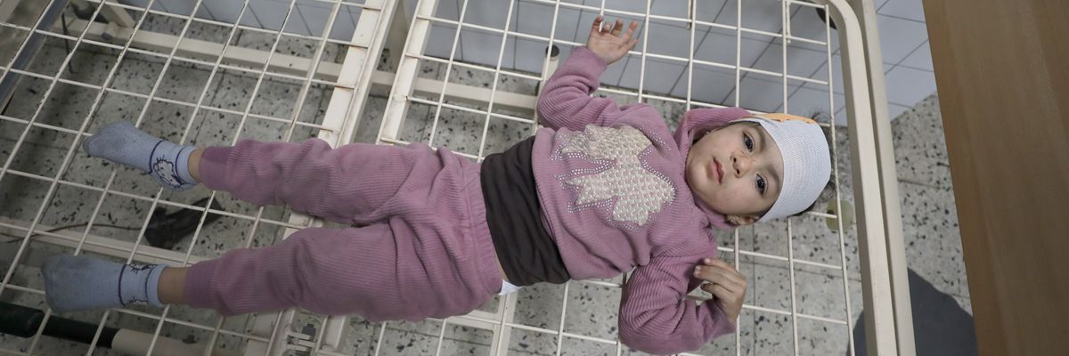 Palestinians, including children, injured in an Israeli attack on Gaza City are brought to Al-Ahli Arab Hospital